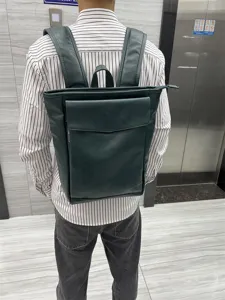 Dark green leather backpack for men, retro campus style student school bag for daily travel.