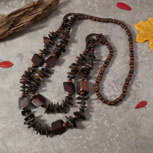 Detailed view of the bohemian wooden bead and coconut shell layered long necklace design.