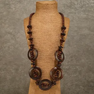 Closeup detail view showing the bohemian style wooden bead coconut shell long necklace.