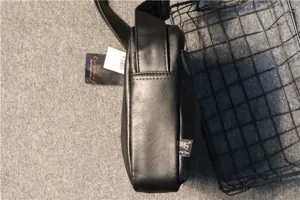 Side detail view of the black men's crossbody bag showing durable PU leather texture and structure.