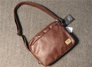 Brown leather men's messenger bag with adjustable shoulder strap and front zip pocket daily use.