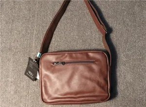 Mens brown leather shoulder bag, casual messenger bag with adjustable strap and front pocket.