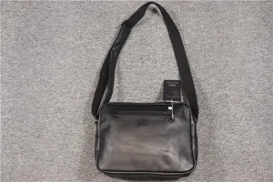 Black minimalist messenger bag detail, casual crossbody style with durable strap and zip pocket.