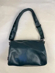 Dark green casual shoulder bag with adjustable strap and flap design, detailed view.
