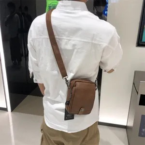 Casual Japanese soft leather vertical crossbody bag for men, stylish daily shoulder travel bag.