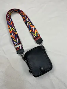 Men vertical crossbody bag detail view, stylish wide colorful strap, simple black shoulder bag.