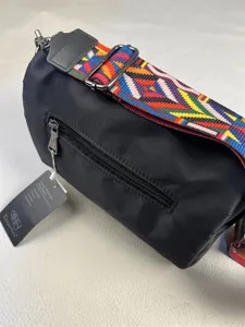 Detailed view of black nylon crossbody bag strap zipper feature casual style daily use accessory