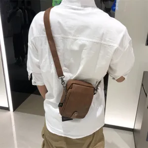Men's brown leather crossbody bag vertical casual sling bag for daily travel and outdoor use