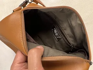Detailed interior view of the brown shoulder bag showing inner lining and zipper.