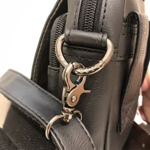 Black men vertical crossbody bag metal hardware detail, soft leather shoulder bag strap ring.