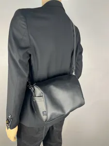 Casual minimalist shoulder bag for men and women, stylish commuter crossbody bag.