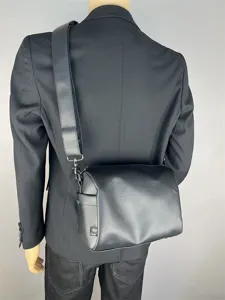 Black nylon crossbody bag for men and women, casual commuter shoulder bag with wide strap.