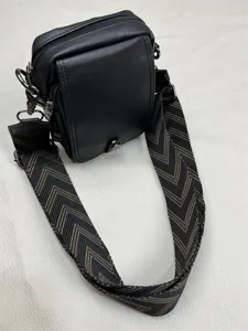 Men's stylish black vertical crossbody bag with wide chevron strap and multi-pockets.