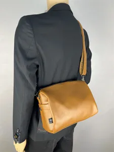 Casual commuter shoulder bag for men and women stylish brown crossbody bag versatile design.
