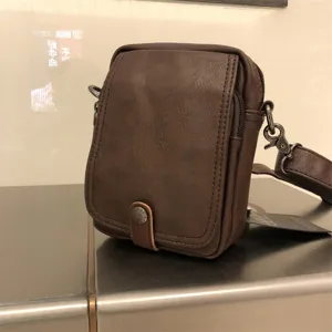Brown leather crossbody bag detail, casual vintage style vertical shoulder bag for men.