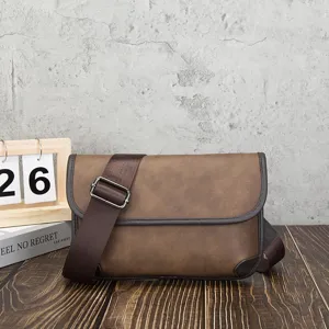 Close-up detail of retro brown messenger bag, soft leather texture, adjustable strap.