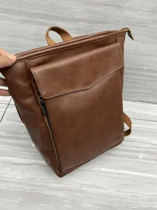 Brown PU leather backpack detail, retro style school bookbag and casual travel daypack for men.