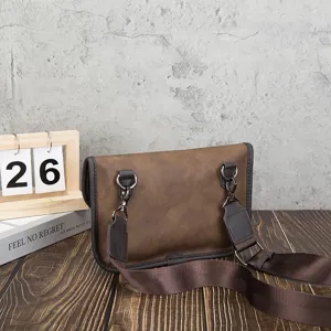 Detailed view of retro brown PU leather shoulder bag with adjustable strap and metal hardware.