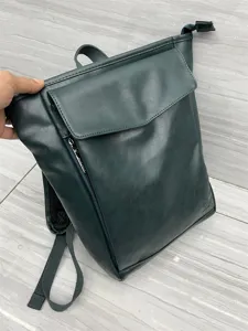 Dark green PU leather backpack for men and women, Japanese style casual campus school bag.