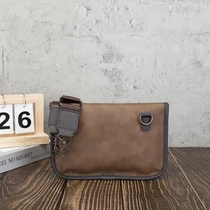 Detail view of retro brown soft leather crossbody shoulder bag with metal D-ring hardware.