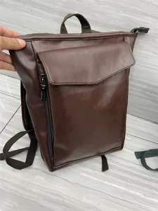 Dark brown leather casual backpack for men and women, stylish school bookbag for travel.