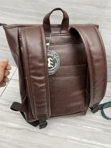 Detailed view of the dark brown PU leather backpack showcasing back straps and texture.