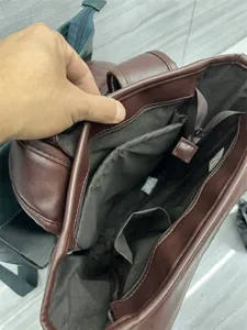 Brown PU leather backpack interior detail, multi-pocket casual school book bag travel.