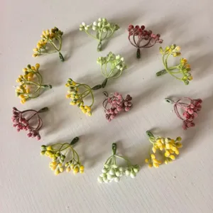 Flocked berry stems detail, colorful artificial fruit branches for DIY crafts and floral decor.