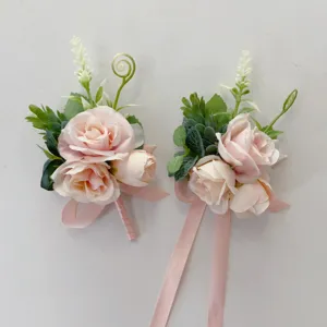 Detailed view of pink artificial flower corsage featuring exquisite rose for wedding decor.