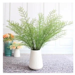 Artificial fern plant branches in white vase, realistic green leaves for home decor arrangement.