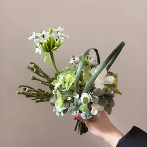 Detailed shot of artificial mixed flower bouquet, elegant green and white floral decor.