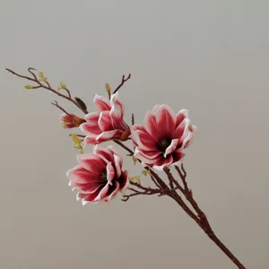 Close up detail of artificial magnolia flower branch with red and white soft touch petals.
