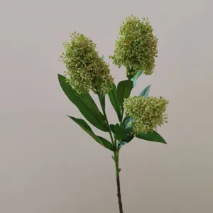 Detailed close-up shot of artificial skimmia flower branch with realistic green buds.