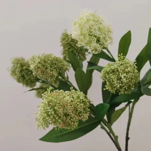 Artificial Skimmia branches detail close-up, realistic green berries and leaves for floral decor.