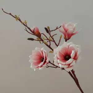 Close-up detail of artificial magnolia branch, pink and white EVA silk flower for home decor.