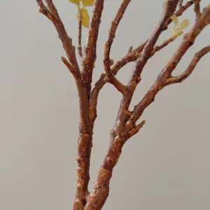 Close-up detail view of artificial magnolia tree branch showing realistic bark texture.