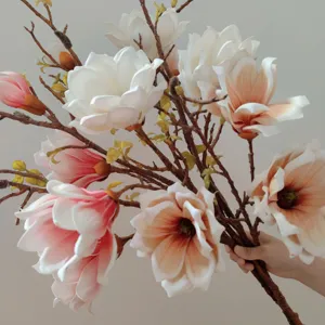 Detailed view of large artificial magnolia flower branch with realistic touch for home.
