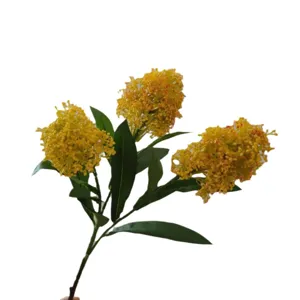 Artificial skimmia flower branch with three yellow flower heads and green leaves for home decor.