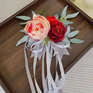 Detailed view of artificial wedding pew flower decoration with peonies and ribbons.