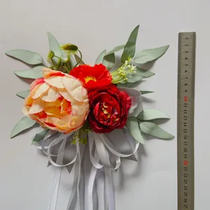Artificial flower decoration for wedding chair, party, and stair decor with vibrant peony and ribbons.