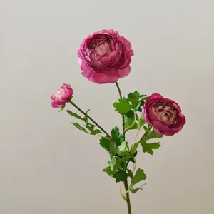 Close-up detail of three-head artificial ranunculus flower, silk floral decor for background.