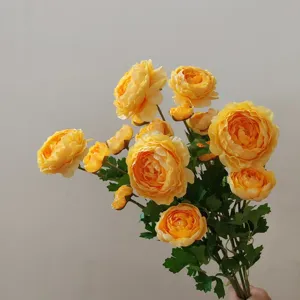 Yellow artificial ranunculus silk flowers bouquet for home decor and photography props.