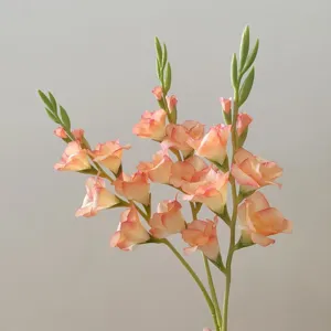 Artificial gladiolus flower detail shot peach pink floral decor branch close up view