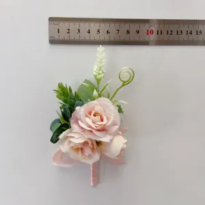 Pink artificial rose flower corsage boutonnière for wedding bride bridesmaid photography.