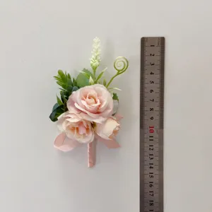 Pink artificial flower boutonniere for wedding bride bridesmaid, delicate floral detail.