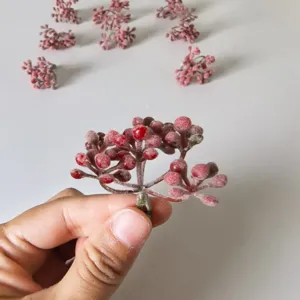 Detailed shot of flocked berry simulation plant accessory for DIY floral crafts and garlands.