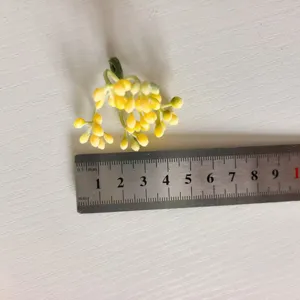 Artificial flocked yellow berry fruit stems floral DIY craft garland accessories detail view.
