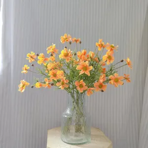 Artificial cosmos flowers in glass vase faux daisy bouquet home decor tabletop floral arrangement.
