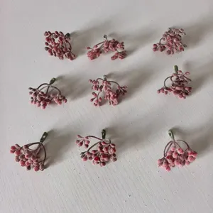 Frosted artificial berry clusters for DIY wreaths, crafts, and floral arrangement accessories.