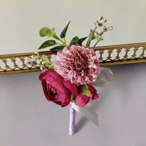 Artificial flower boutonniere detail shot, elegant purple and pink suit lapel flower for wedding.